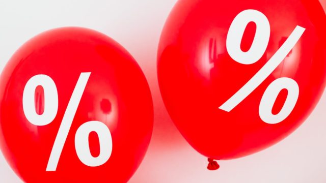 two red balloons with percentage symbols on white background